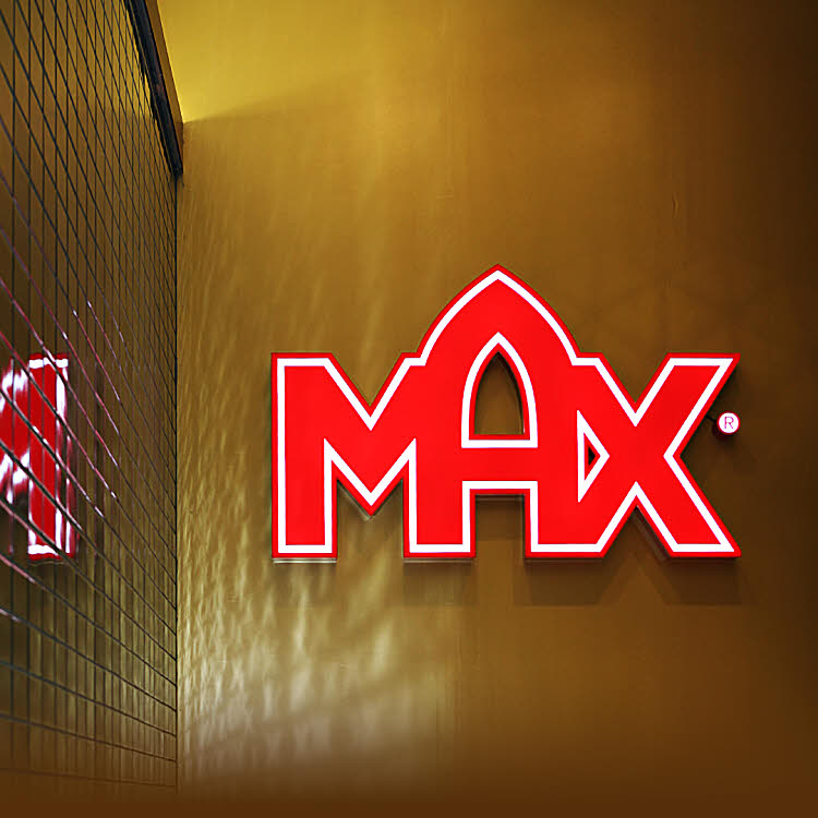MAX Logo in bright red on wall. Photo.